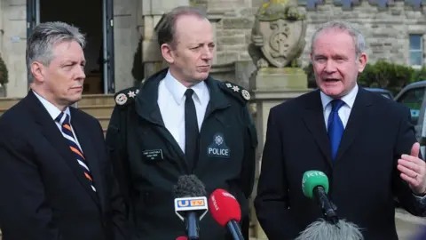 Pacemaker Martin McGuinness with Peter Robinson and Chief Constable Hugh Orde