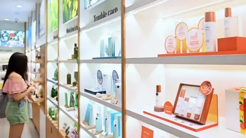 Getty Images A woman browsing products at a store