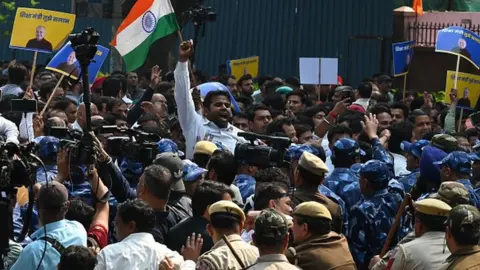 Getty Images AAP party workers shouts slogans during a protest against the arrest of Manish Sisodia , at the BJP office at DDU Marg , on 27 February 2023 in New Delhi