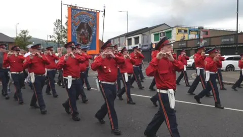 Pacemaker Orangemen passing outside Ardoyne shops in 2019