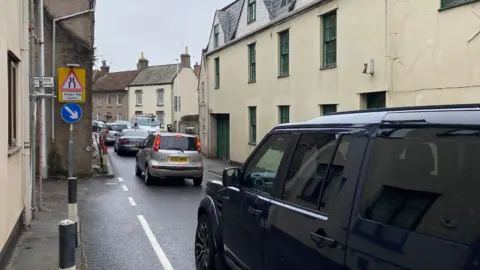 John Wimperis A congested street in Banwell in North Somerset