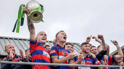 Neil G Paterson Kingussie with Camanachd Cup