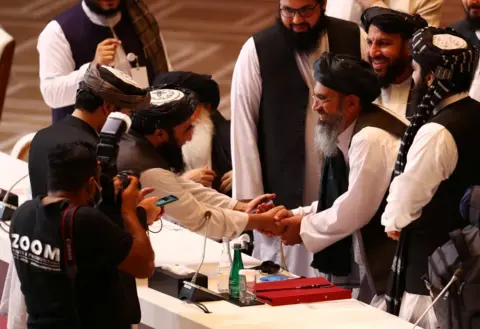 Getty Images Taliban delegates shake hands