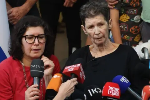 EPA Yocheved Lifschitz (C), 85, speaks with the media next to her daughter Sharone