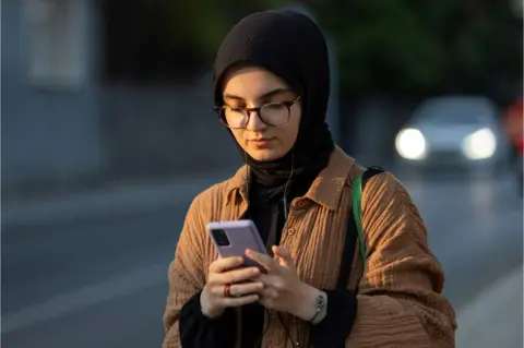Getty Images Muslim lady on a phone