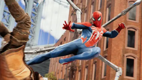 Marvel An action shot from Spider-Man 2 of the superhero flying through the air, kicking an enemy to the ground. Spider-Man has articulated spider legs emerging from his back, and the enemy, wearing a light brown jacket with dark brown arms, has his arms up over his head as he falls to the ground.