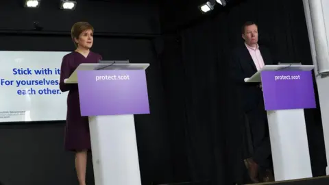 Getty Images Ms Sturgeon, seen here with Jason Leitch, gave regular news conferences throughout the pandemic