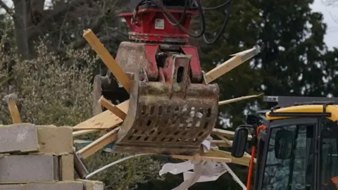 PA Media Work continues to demolish an unauthorised spa pool block at the home of Hannah Ingram-Moore, the daughter of the late Captain Sir Tom Moore, at Marston Moretaine, Bedfordshire