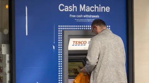 Getty Images Man at Tesco Bank ATM