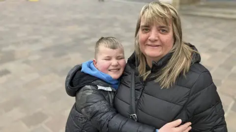 Steve Jones/BBC Joanne Robinson and her son Flyn