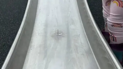 Nail pointing upwards children's slide