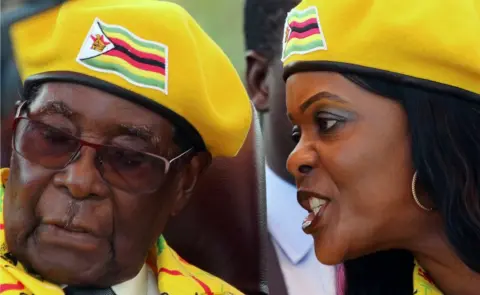 AFP President Robert Mugabe listens to his wife Grace Mugabe at a rally of his ruling ZANU-PF party in Harare, Zimbabwe, November 8, 2017
