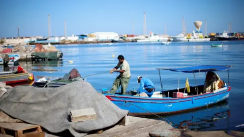 EPA Libyan fishermen moor their boat at Tripoli harbour, Libya November 3, 2017.