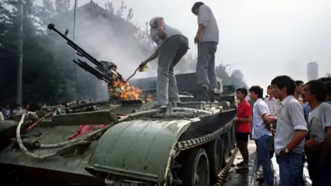 Getty Images A burning APC on 4 June 1989 near Tiananmen Square
