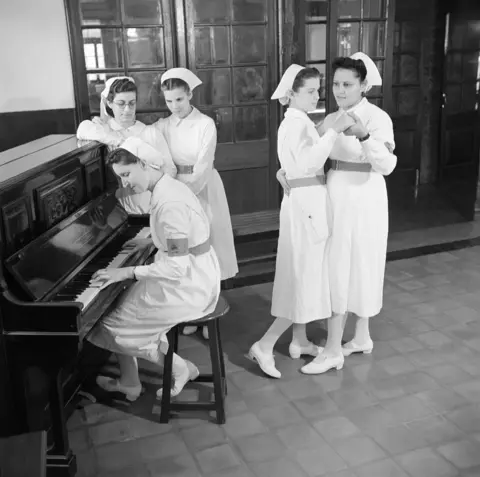 BBC A group of trainee nurses entertain themselves while on a break