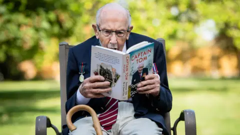Getty Captain Sir Tom Moore reading his autobiography