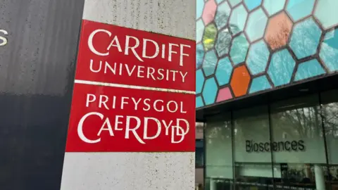 BBC A shot of Cardiff University's logo outside a building in the city.