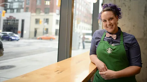 Getty Images Starbucks relaxed their already laid-back dress policy and now encourages workers to sport hats and coloured hair (Credit: Getty Images)
