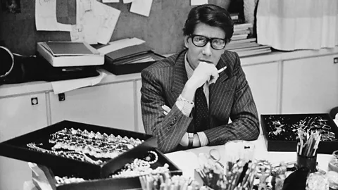 Musée Yves Saint Laurent Paris/DR Saint Laurent, seen here in his studio in 1986, has retained his cult appeal decades later (Credit: Musée Yves Saint Laurent Paris/DR)
