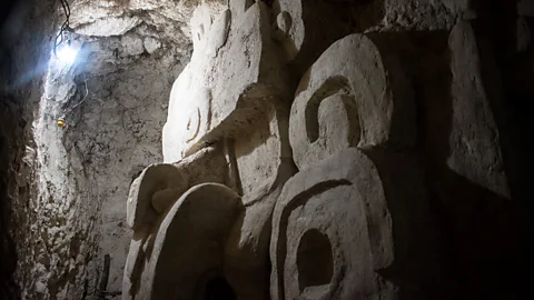 Amanda Ruggeri A Maya carving dating to the 5th Century AD looms out of the dark at El Zotz (Credit: Amanda Ruggeri)