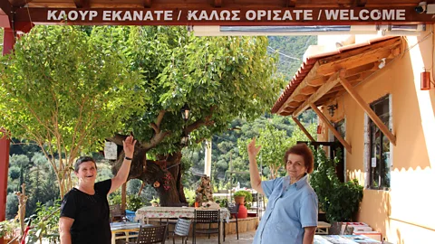 Angela Dansby Signs in both ancient Tsakonian and modern Greek welcome visitors in the village of Pera Melana (Credit: Angela Dansby)