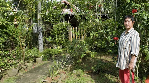 AFP Stringer/Getty Images Sng Mui Hong is the village's landlady and has lived here since before Singapore was its own country (Credit: AFP Stringer/Getty Images)
