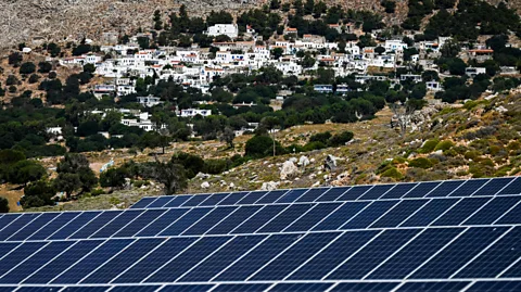 Getty Images Tilos uses a combination of solar and wind energy to power its population, and uses battery technology to store the surplus (Credit: Getty Images)