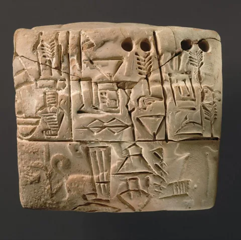 Getty Images A Mesopotamian cuneiform tablet from Uruk, featuring an impression of a male figure, hunting dogs, and boars (Credit: Getty Images)