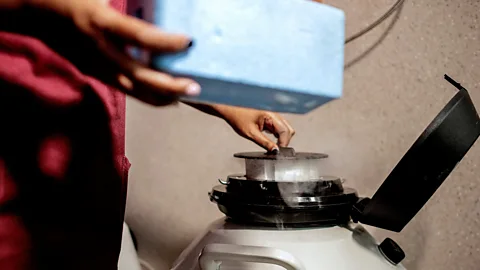 Getty Images Hands extracting material from cryogenic container (Credit: Getty Images)